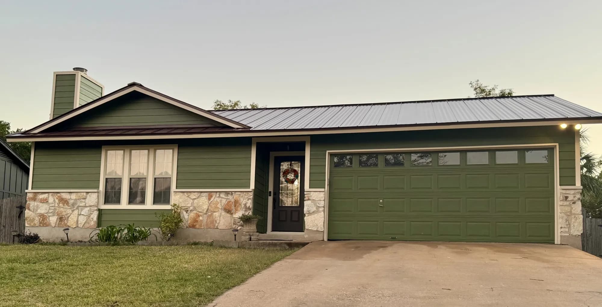 Austin home with a new metal roof, siding, and paint by PT Roofing & Renovations